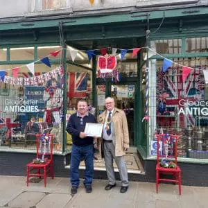 Coronation Best Dressed Window Competition - Winner - Gloucester Antiques Centre. Certificate accepted here by Denzil on behalf of the owners Min and Mick.